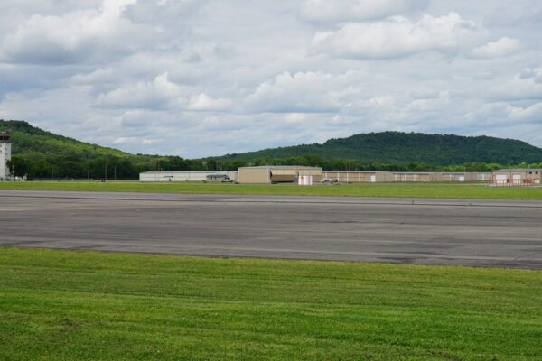 Control tower, hangars and runway at Drake Field in Fayetteville, Arkansas, under a cloudy sky