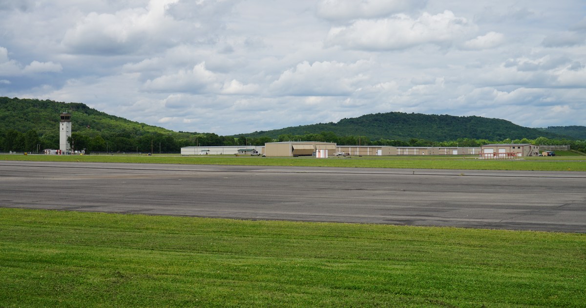 Control tower, hangars and runway at Drake Field in Fayetteville, Arkansas, under a cloudy sky