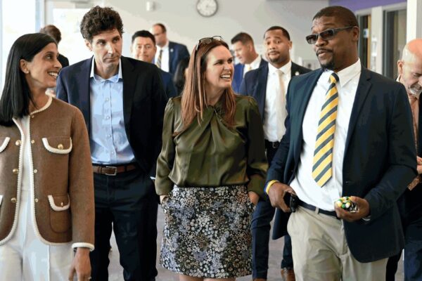Usha Vance and Gov. Sarah Huckabee Sanders walk through a hallway at Glenview Elementary School with school and state officials